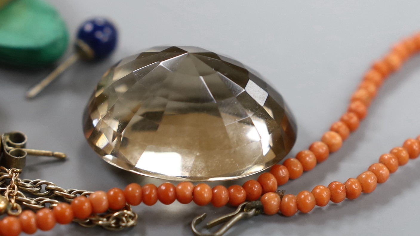 A group of mixed jewellery to include a yellow metal mounted amethyst pendant, a small coral bead necklace, ear studs, unmounted quartz and a 9ct mounted cameo brooch.